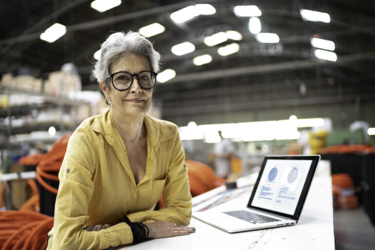 Portrait of a businesswoman using laptop and working in a factory